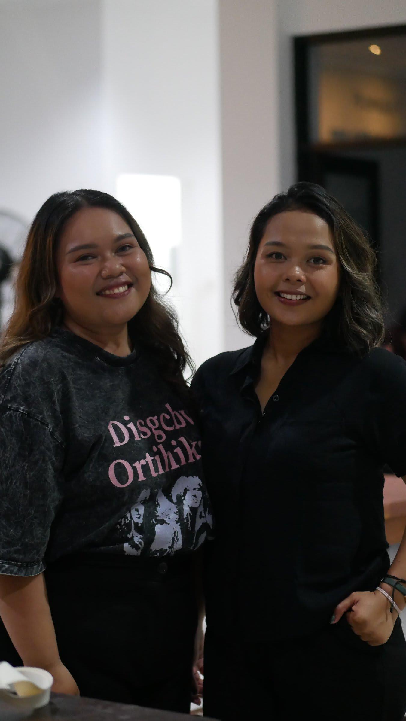 Two friends side by side, smiling warmly after the gathering