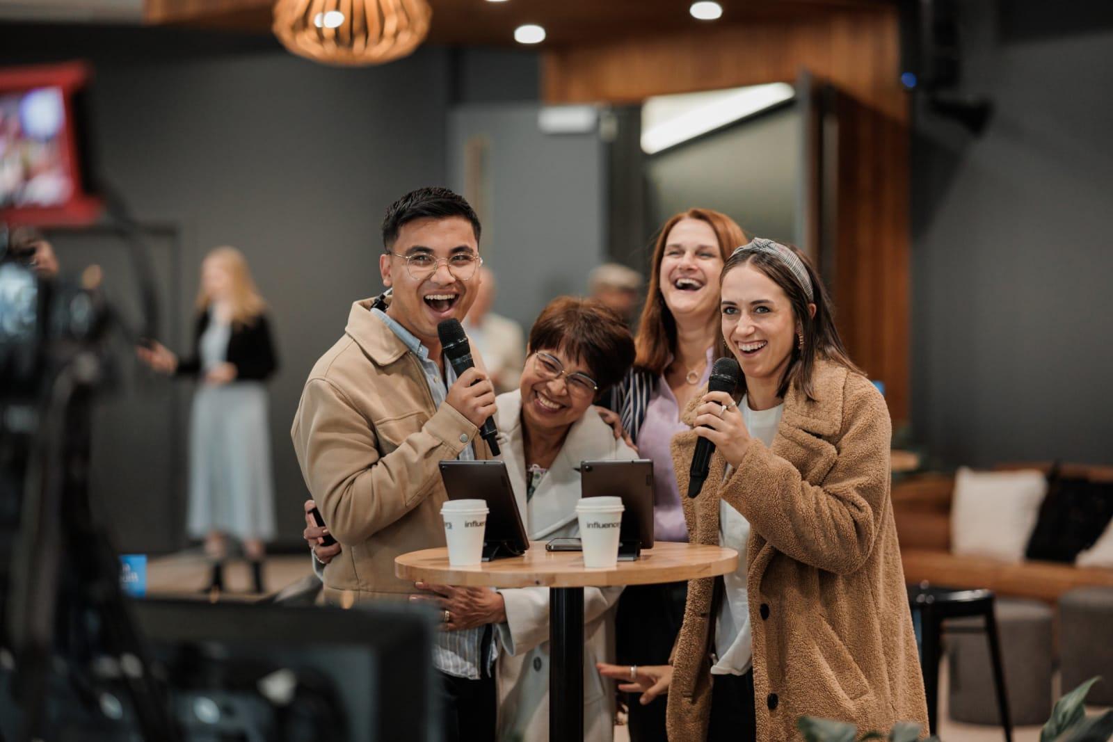 Four people from three generations cracking up around a café table after the service