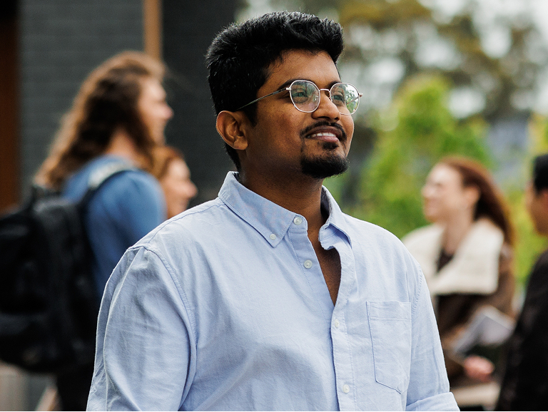 A student looking up to the sky outdoors