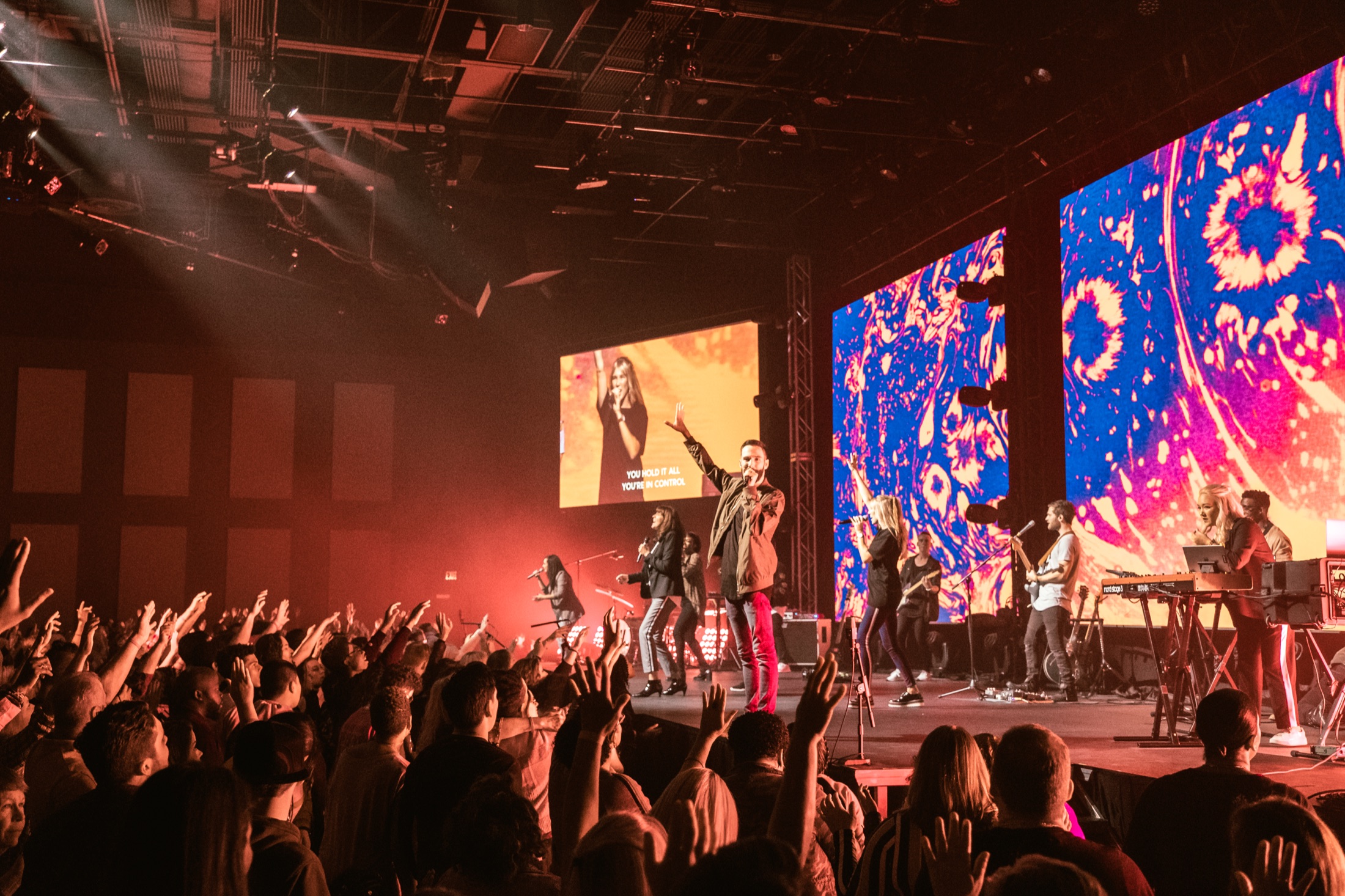 Pastor Ryan leading worship to a packed room at Futures Alpharetta